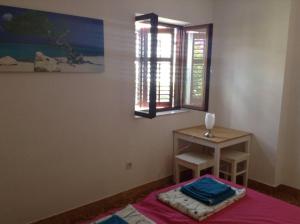 a room with a table and a table and a window at Guest house Perfect Location in Bol +2 photos