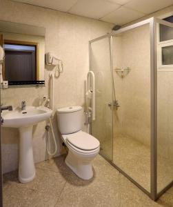 a bathroom with a toilet and a sink and a shower at Al Smou Hotel Apartments - MAHA HOSPITALITY GROUP in Ajman 