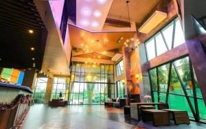 eine Lobby mit Tischen und Stühlen in einem Gebäude in der Unterkunft Ps Extra Hotel in Ban Kohong
