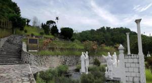 un groupe de statues devant un mur de pierre dans l'établissement Amaris Hotel Palangkaraya, à Palangka Raya