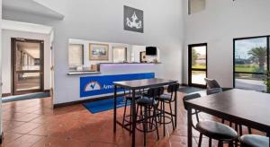 a living room with two tables and chairs at Americas Best Value Inn Gonzales in Gonzales