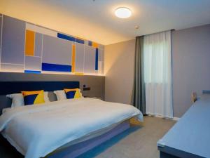 Ένα ή περισσότερα κρεβάτια σε δωμάτιο στο 7 Days Inn Xi'an Railway Station