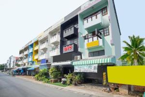 a building with colorful balconies on the side of a street at OYO 723 Lamphun Hostel in Lamphun