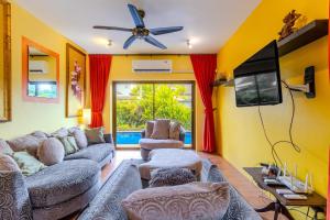 uma sala de estar com sofás e uma TV de tela plana em V265 2BR Pool Villa Near Fitness Gyms Muay Thai em Ban Saiyuan (1)