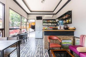 a kitchen and living room with a table and chairs at Hotel O Wisma Pelita Mas in Pampang