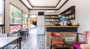 a room with a bar with chairs and a table at Hotel O Wisma Pelita Mas in Pampang +43 photos