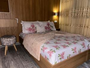 a bedroom with a large bed with pink flowers at Sidi ifni hébergement in Sidi Ifni