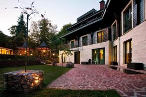 a house with a brick walkway next to a building at Vila 6aTo Hotel & Wellnes in Sofia