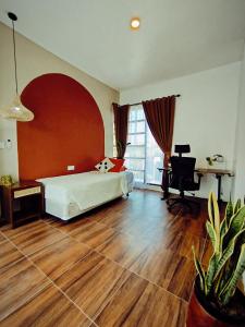 a bedroom with a bed and a desk and a computer at Villa Omah H 25 in Ungasan +15 photos