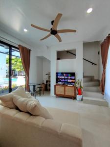 un salon avec un canapé et un ventilateur de plafond dans l'établissement Villa Omah H 25, à Ungasan