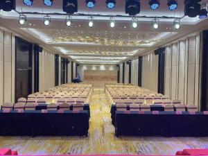 a large room with rows of tables and chairs at Dongguan Jun Hao Hotel in Dongguan