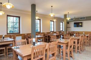 a dining room with wooden tables and chairs at Penzion Čekanka in Strážné