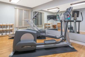 a gym with a treadmill in a room at Super 8 by Wyndham Bloomington/Airport in Bloomington