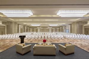 a large room with a rows of chairs and a stage at DoubleTree by Hilton Agra in Agra +60 photos