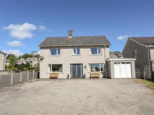 a large white house with a driveway at Glan Aber in Pwllheli
