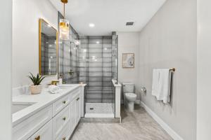 a white bathroom with a sink and a toilet at 30 8th Avenue in Indialantic +52 photos