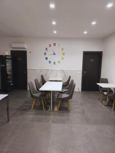 那不勒斯Allegro Hotels的一间设有桌椅和墙上时钟的房间 更多28张照片