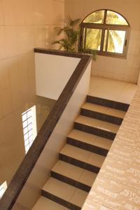 a set of stairs in a room with a window at Hotel Residence Flamani in Lomé