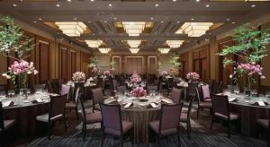 a banquet hall with tables and chairs and flowers at Nippondaira Hotel in Shizuoka