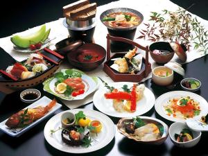 a table with many plates of food on it at Sunshine Shirako New in Shirako