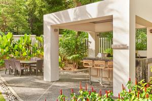 an outdoor patio with a table and chairs at Orchard Scotts Residences by Far East Hospitality in Singapore