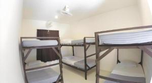 a room with three bunk beds in a room at Perhentian Tivoli Inn in Kampong Pasir Panjang