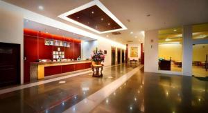 a large kitchen with a vase of flowers on a table at Kingwood Hotel Mukah in Mukah