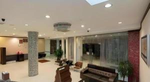 a large living room with a couch and chairs at S Bee Hotel in Johor Bahru