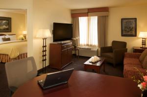 a hotel room with a bed and a laptop on a table at Larkspur Landing Campbell-An All-Suite Hotel in Campbell