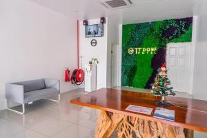 a living room with a christmas tree on a wooden table at TT Dorf Hotel (Taiping) in Taiping