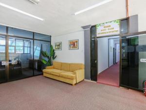 an office with a couch in the middle of a room at OYO 89922 The Sarina Hotel & Cafe in Kampong Bukit Susun