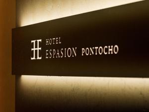 a sign for a hotel evacuation portochino on a wall at Hotel Espasion Pontocho in Kyoto