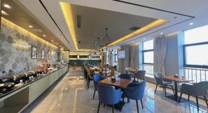 a restaurant with tables and chairs and a buffet at Jinjiang Inn Select Xinji Xinghua Road in Xinji