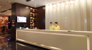 two men standing at a counter in a restaurant at Zmax Changzhi Bayi Square in Changzhi