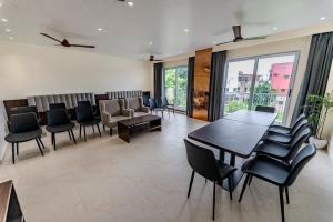 a waiting room with a table and chairs at swastik stays in Prayagraj