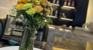 a vase filled with flowers sitting on a table at Xana Hotelle Shenyang Zhongshan Plaza the Affiliated First Hospital of China Medical University in Shenyang