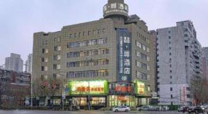 a large building in the middle of a city at James Joyce Coffetel Shenyang North Railway Station Qishan Road Metro Station in Shenyang