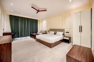 a bedroom with a bed and a green curtain at swastik stays in Prayagraj +41 photos