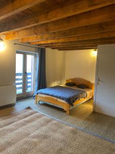 a bedroom with a bed and a large window at Chalet coeur d'alpage La Plagne Les Arcs in La Plagne Tarentaise