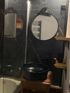 a bathroom with a sink and a mirror and a tub at Chalet coeur d'alpage La Plagne Les Arcs in La Plagne Tarentaise
