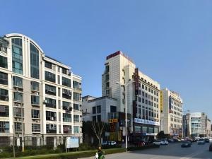 a city with tall buildings and a street with cars at Super 8 Hotel Shanghai Songjiang University Town Branch in Songjiang