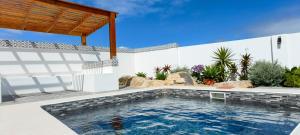 a swimming pool in the backyard of a house at Black Eagle's Rest #Unit 1-8 in Langebaan