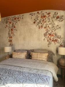 a bedroom with a bed with flowers on the wall at Dreamhome B&B Limoux in Limoux +43 photos