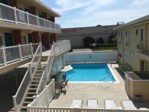 a swimming pool in the courtyard of a building at Seahorse Inn in Wildwood