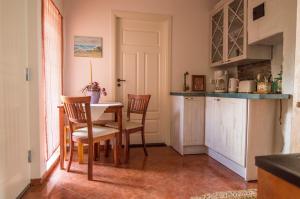 a kitchen with a table and chairs in a room at Theodori Holiday House in Pärnu +18 photos