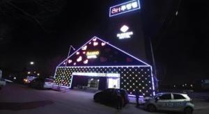 a building with lights on it with a street sign at SH Hotel in Anggam