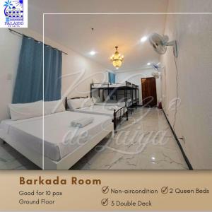 ein Schlafzimmer mit zwei Betten und einem Deckenventilator in der Unterkunft Palazio De Laiya Resort Hotel in San Juan