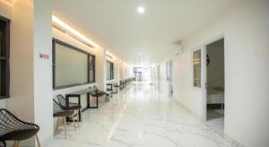 a hallway with chairs and a large screen on the wall at My Stay Semarang in Candi