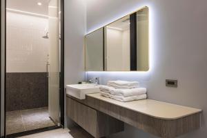 a bathroom with a sink and a mirror and towels at Triple Suite Villa BnB in Magong +53 photos