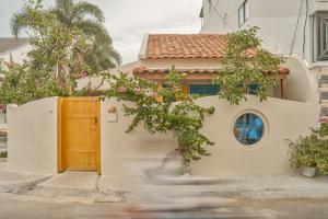 une maison avec une porte et un arbre dans l'établissement The 37Villa Phan Thiet by 89living, à Phan Thiết